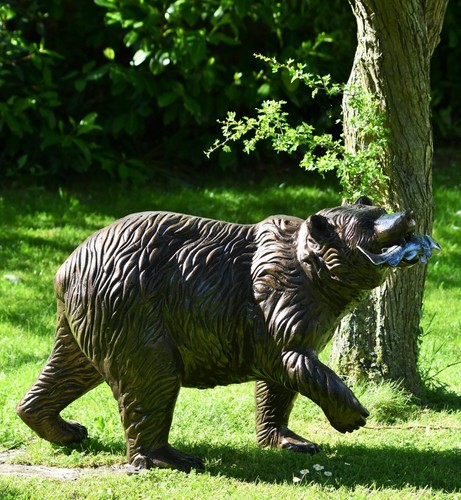 Bear cub with fish sculpture